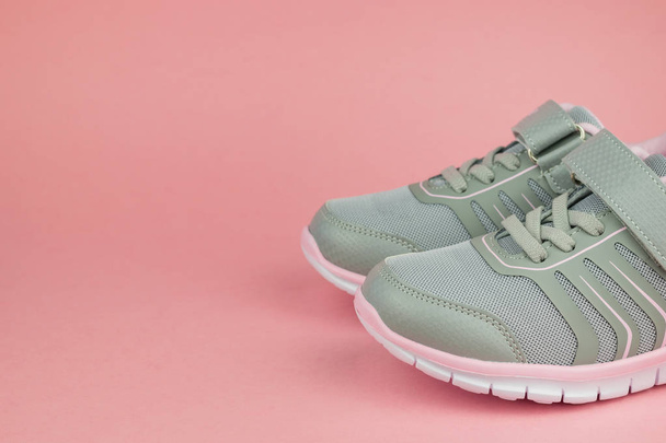 Fashion women's sneakers gray and pink on a pastel background. - Photo, Image