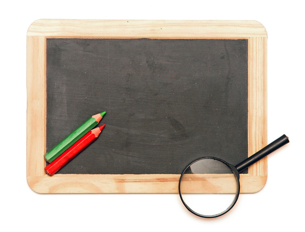 Colorful pencil with magnifying glass on blank blackboard - Photo, Image
