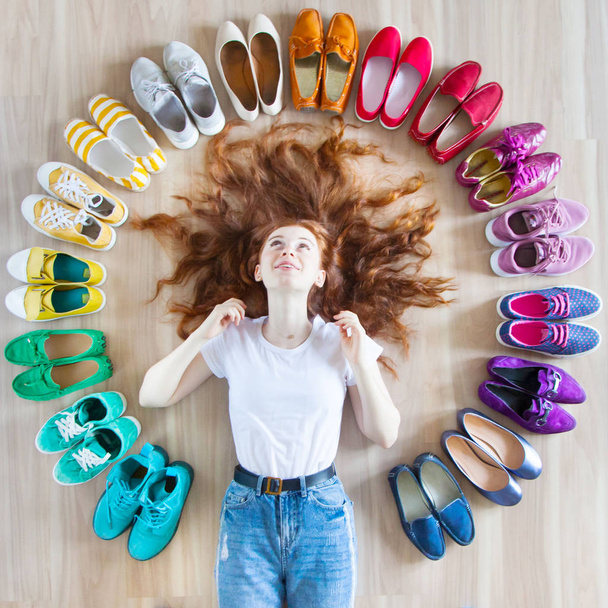 A lot of colored women's shoes on the floor. A woman chooses her - Fotó, kép