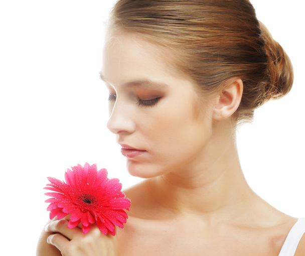 Beautiful young woman with gerber flower - Фото, изображение