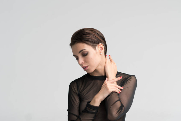 young beautiful girl stands in black transparent underwear - Fotó, kép