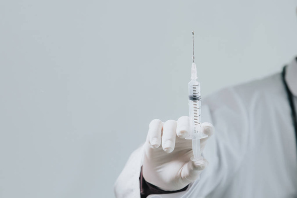 Doctor holding medical injection syringe.Medical treatment conce - Photo, Image