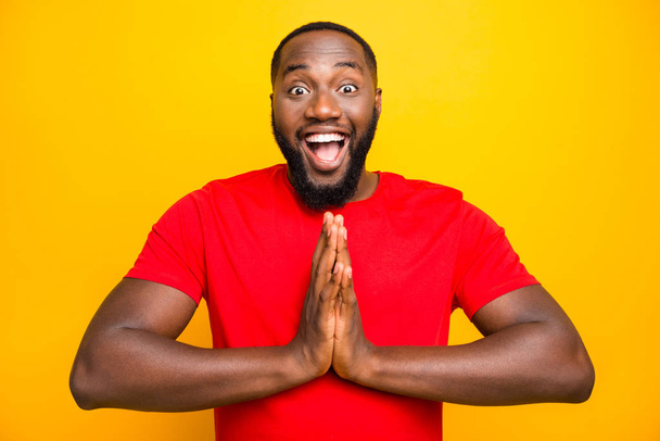 Photo of funny nice cute black man begging someone praying expecting while isolated with yellow background - Zdjęcie, obraz