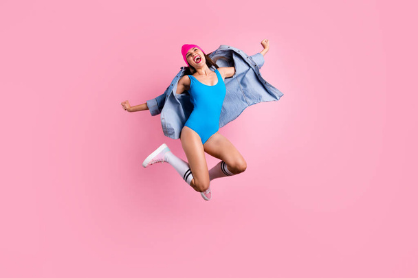 Full size photo of cheerful lady screaming yeah raising her hands wearing blue body suit swimsuit isolated over pink background - Foto, immagini
