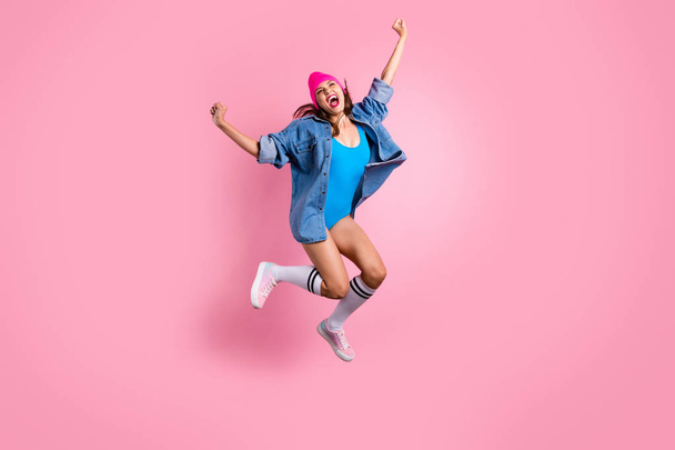 Full size photo of cute lady screaming shouting yeah raising fists wearing blue bodysuit swim suit isolated over pink background - Photo, image