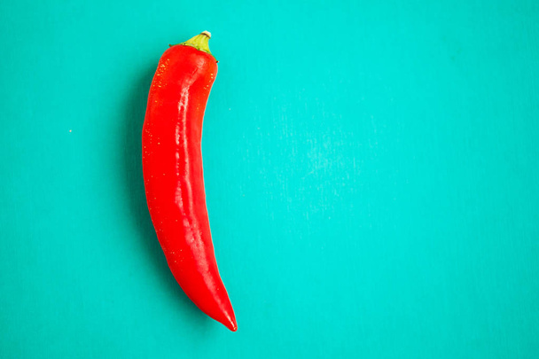 Red chili pepper on turquois background - Φωτογραφία, εικόνα