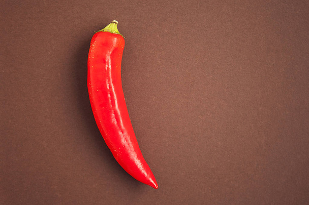 red chili pepper on brown background - Foto, Imagem