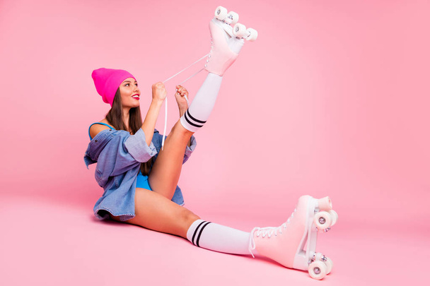 Full length photo of cute youngster wearing quads raising her foot up having swimsuit socks isolated over pink background - Photo, Image