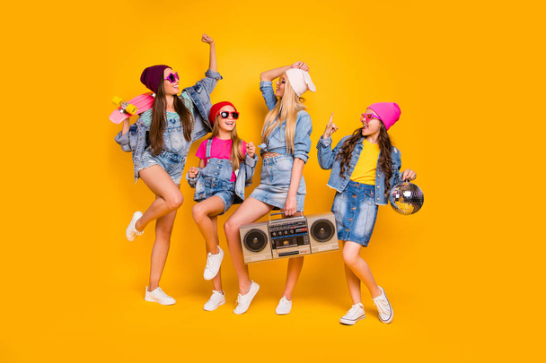Full body size photo of crazy carefree beautiful lifestyle feeling cool wearing denim clothes people dancers millennials chilling out having rest on weekend isolated yellow background - 写真・画像