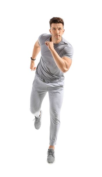 Running young man on white background - Foto, Imagen