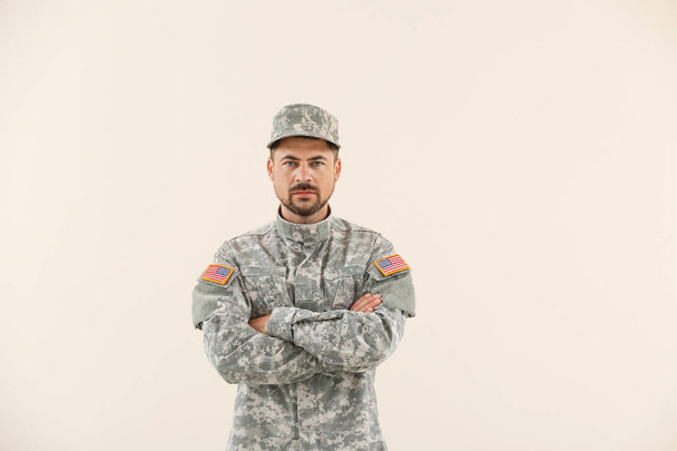 Soldier in camouflage on light background - Photo, Image