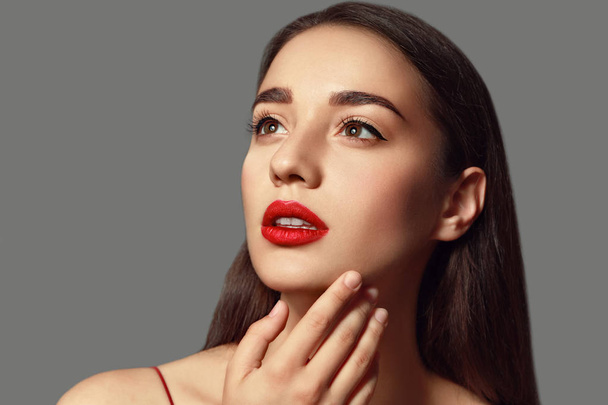 Beautiful young woman with bright lipstick on grey background - Фото, зображення