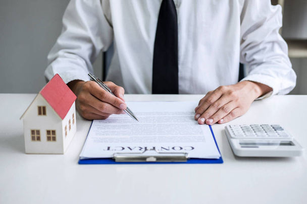 Man sign a home insurance policy on home loans, Businessman sign - Fotó, kép