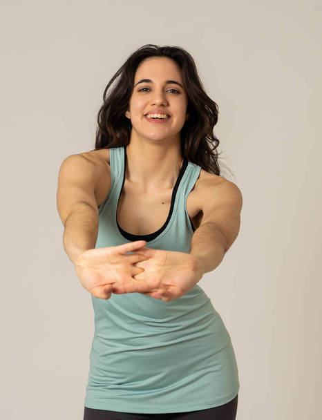 Cheerful latin strong woman in sportswear looking healthy and sexy. Portrait of fit young woman wearing gym top posing happy and funny in stretching and workout poses In Fitness and Body care concept. - Φωτογραφία, εικόνα