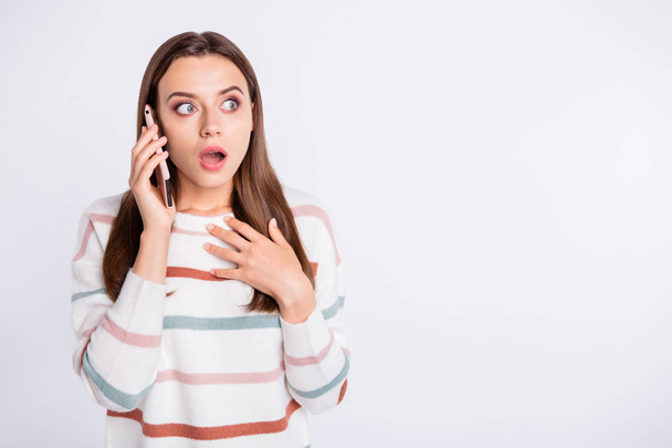 Pretty lady speaking over telephone listening shocking news wear striped pullover isolated white background - Photo, image
