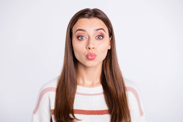 Photo of overjoyed lady sending air kiss to boyfriend wear striped pullover isolated white background - Foto, Imagen