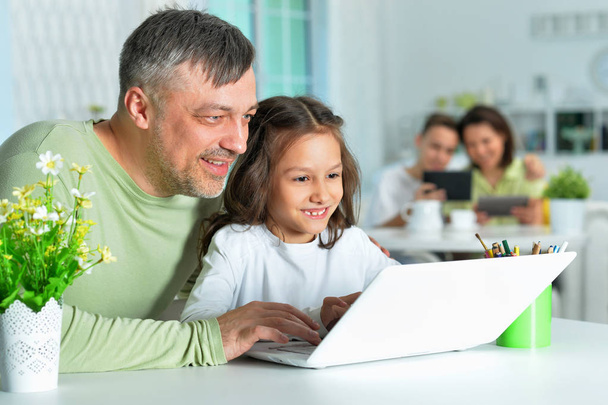 Vater mit kleiner Tochter nutzt Laptop - Foto, Bild