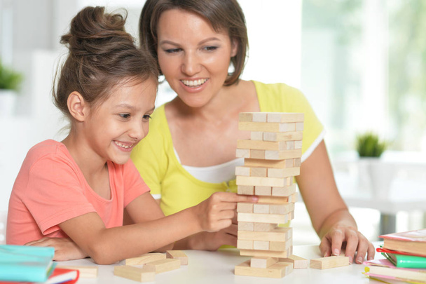  little girl and her mother playing with  blocks at home - Photo, Image
