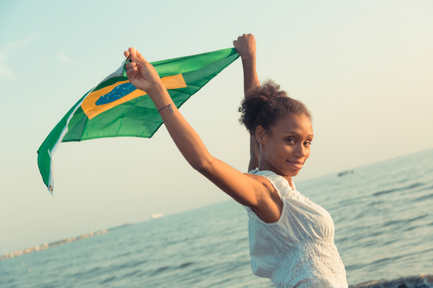 Brazilian Girl with National Flag at Beach - Foto, immagini