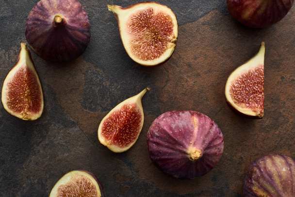 top view of ripe whole and cut delicious figs on stone background - Φωτογραφία, εικόνα
