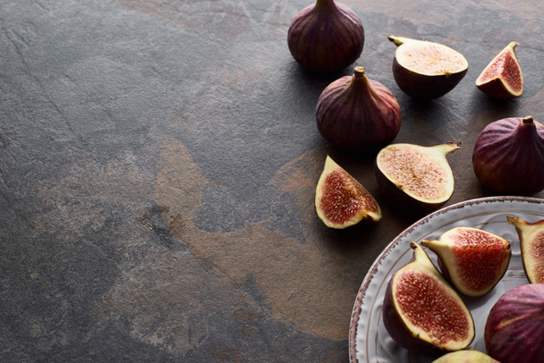 ripe whole and cut delicious figs on white plate stone background - Fotoğraf, Görsel