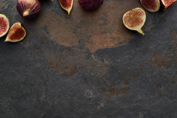 top view of ripe whole and cut delicious figs on stone background - Photo, Image