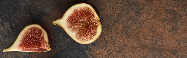 panoramic shot of ripe cut delicious figs on stone background - Foto, immagini
