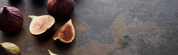 panoramic shot of ripe whole and cut figs on stone textured background - Fotografie, Obrázek