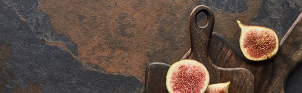 top view of delicious figs and wooden cutting boards on stone background, panoramic shot - Φωτογραφία, εικόνα