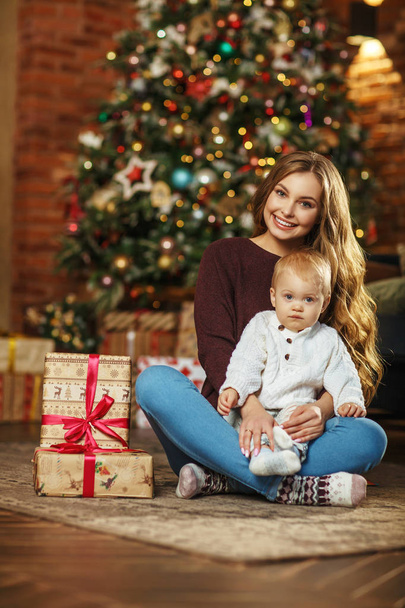 Beautiful mother with her baby son, christmas holiday - 写真・画像