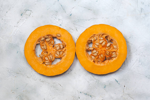 Two Round Sliced Pieces of Fresh Pumpkin. The symnol of tape or wheel - Zdjęcie, obraz