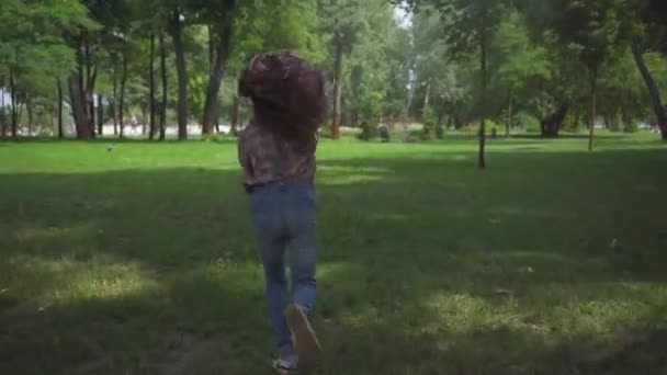 back view of child running with kite in green  park - Materiał filmowy, wideo