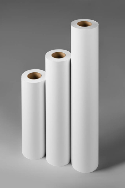 Blank white paper rolls mockup isolated on gray background - Foto, Bild