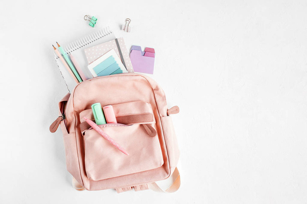 Backpack with school supplies and books for study. Back to school concept. Flat lay, top view  - Valokuva, kuva