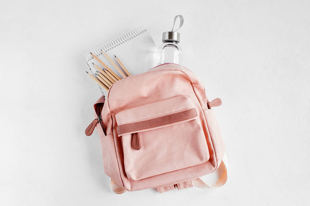 Backpack with school supplies and books for study. Back to school concept. Flat lay, top view  - Φωτογραφία, εικόνα