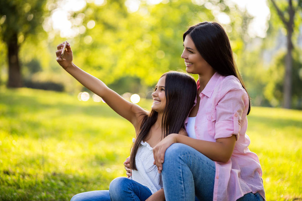 Happy family having nice time in park together. They are taking selfie.  - Photo, Image