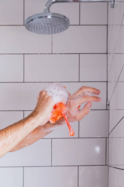 Close-up shot of mans hands in the shower - Photo, Image