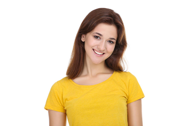 Young woman in yellow t-shirt on white background - Valokuva, kuva