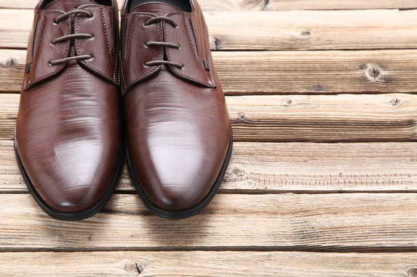 Male leather shoes on brown wooden table - Foto, Imagem