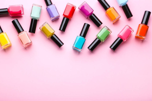 Nail polish bottles on pink background - Foto, imagen