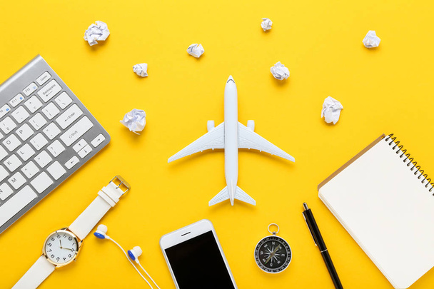 Airplane model with paper clouds, keypad, notepad, smartphone an - Φωτογραφία, εικόνα