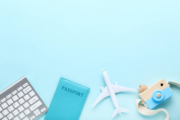 Airplane model with keypad, passport and camera toy on blue back - Фото, зображення