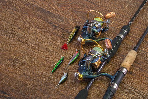 Fishing tackle - fishing spinning, hooks and lures on darken woo - Photo, Image