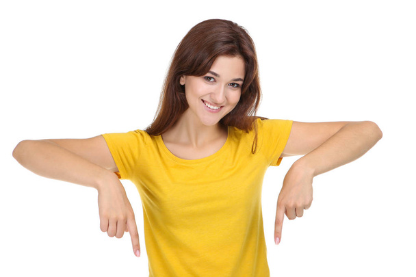 Young woman in yellow t-shirt on white background - Fotografie, Obrázek