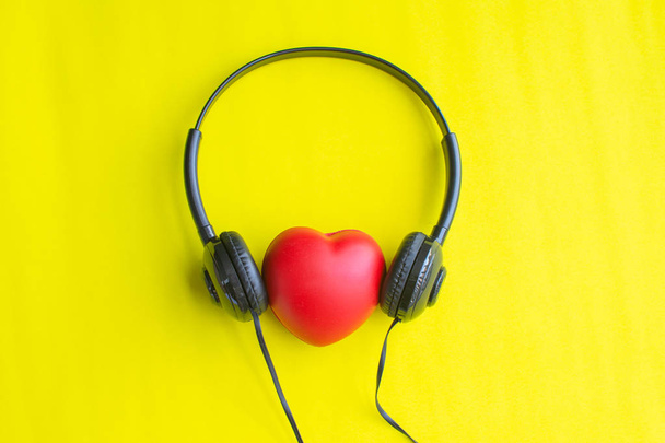 red heart with earphone, sound of love, soft focus. - Photo, Image
