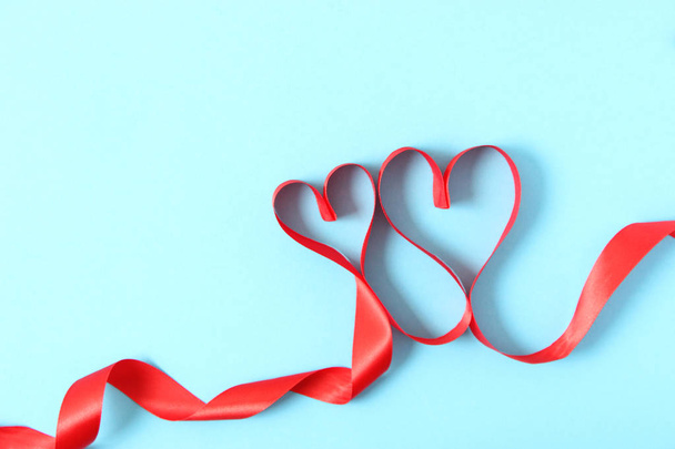 hearts from ribbons on a colored background top view. - Fotografie, Obrázek