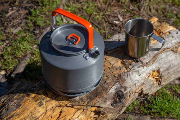 Kettle with a mug in a tourist camp. outdoor recreation in the C - Photo, Image