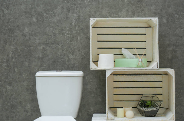 Toilet bowl and decor elements near grey wall. Bathroom interior - Valokuva, kuva
