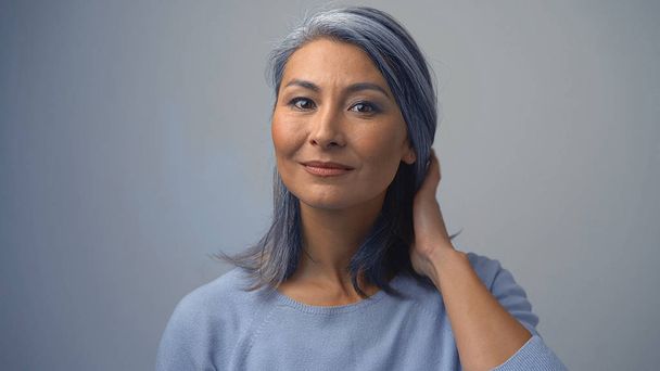 Beautiful Asian Woman Tidying Her Grey Hair - 写真・画像