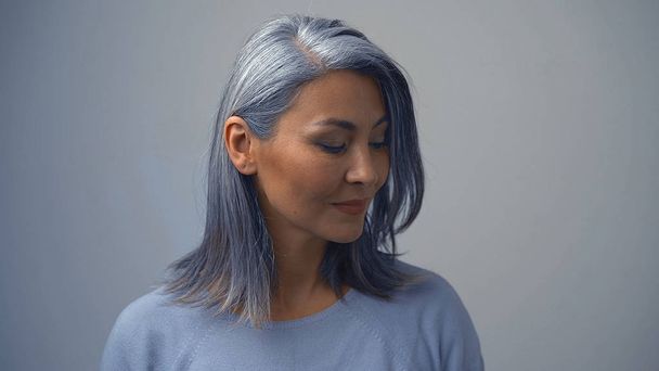 Posing Beautiful Asian Woman On The Grey Background - Zdjęcie, obraz